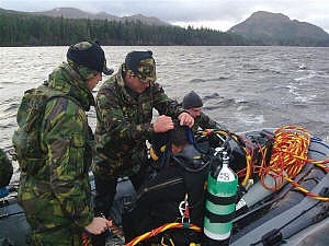 The divers prepare to plunge into a chilly Loch Laggan near Fort William as they carry out their altitude diving exercise.