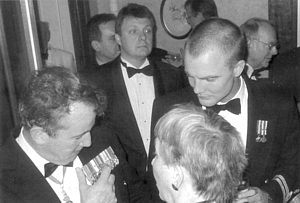 Mark Northcote looks on as Cdre Miller explains his medals