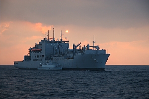 HMS Blyth fuels alongside USNS Lewis and Clark as the sun sets on another day in the Gulf 