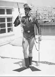 Jackie Rea in Malta presenting arms in cap, sword belt and gaiters